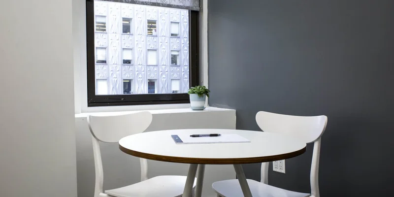 Small meeting area with white chairs.