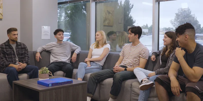 Discussion in a group therapy space with chairs in a  circle.