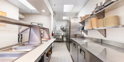 Commercial kitchen with serving counter and stainless appliances