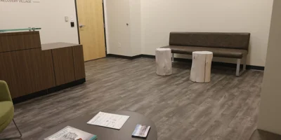 Reception area with a desk and seating in a rehab facility.
