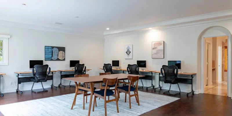 Study area with desks, chairs, and computers.