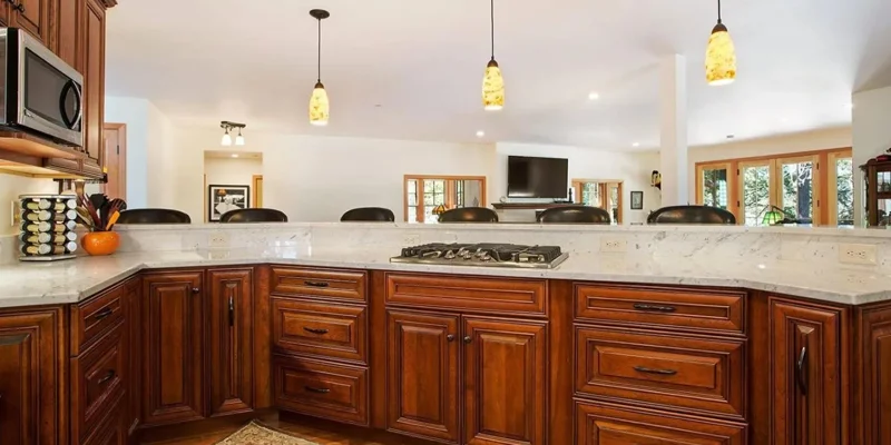 Kitchen with seats behind counter.