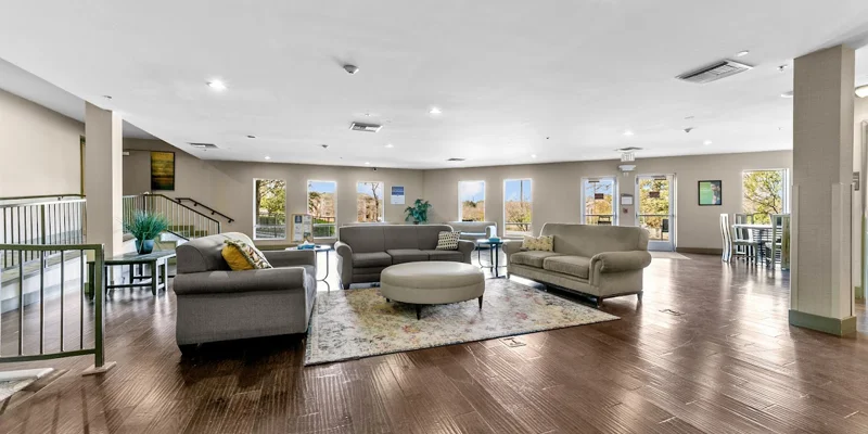 A rehab facility lounge with seating and bright windows.