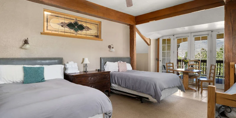 Shared bedroom with two beds and nightstands.