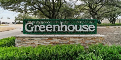  A large sign with "Greenhouse" at a rehab center entrance.