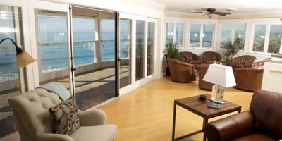 Cozy lounge with ocean-facing windows.