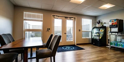 Dining space with table, chairs, beverage cooler, and snack station.