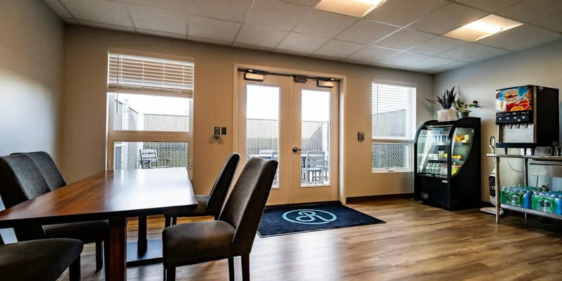 Dining space with table, chairs, beverage cooler, and snack station.
