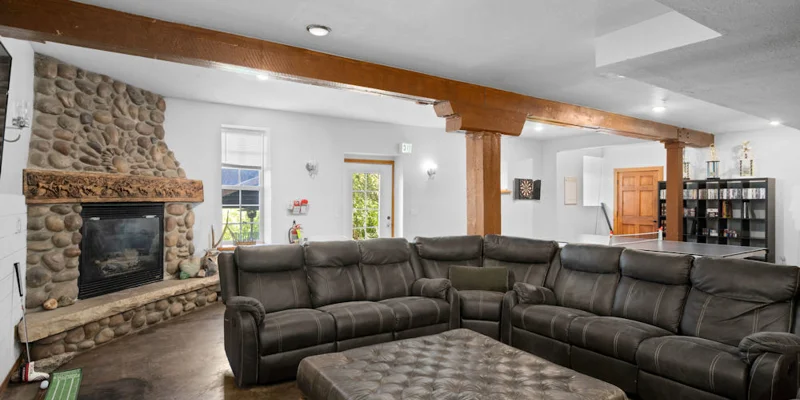 Lounge area with seating, a fireplace and TV.