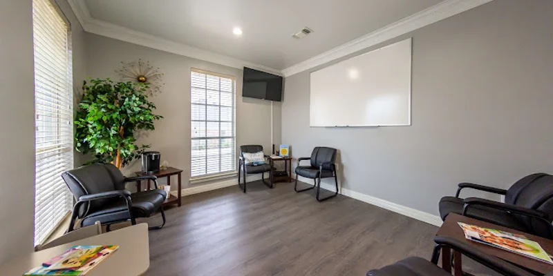 Group meeting room with black chairs and a whiteboard.