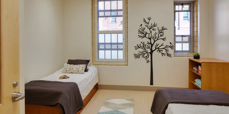 Shared room with a cozy beds and amenities for patients.