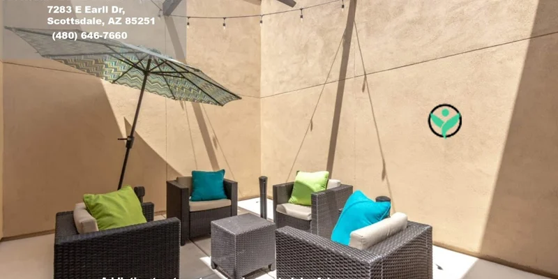 Outdoor courtyard with seating and an umbrella.