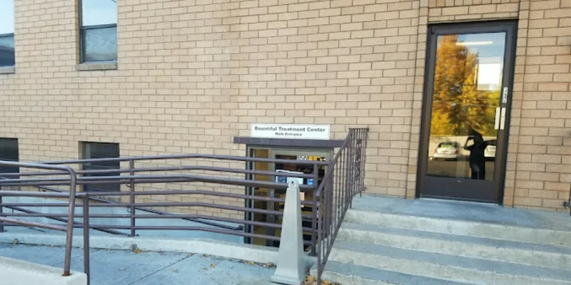 Facility entrance with stairs and a ramp.