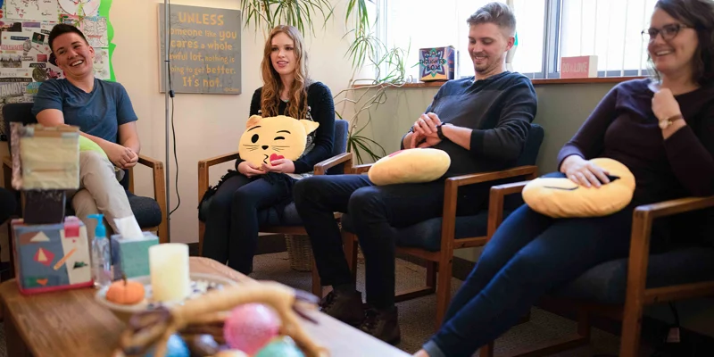 A group therapy session with people seated in a room.