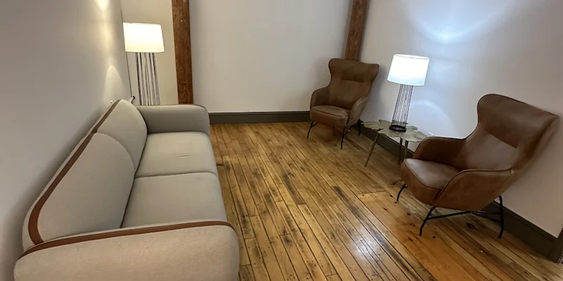Private therapy room with a sofa and two armchairs