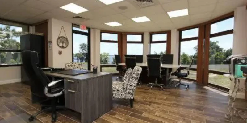 Office space with large windows and desks.