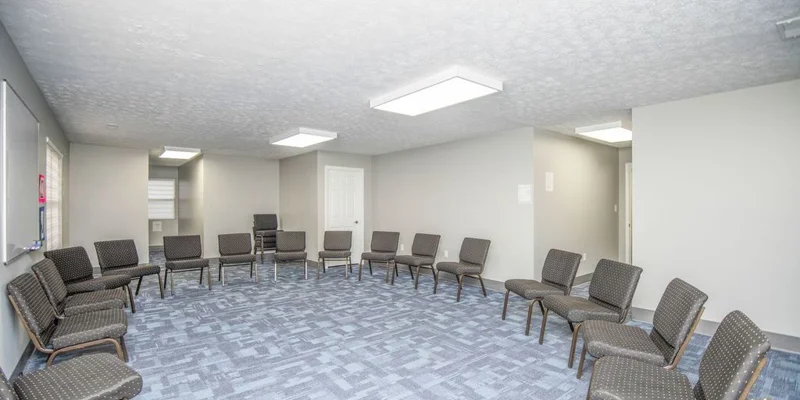 Large group therapy room with chairs arranged in a circle