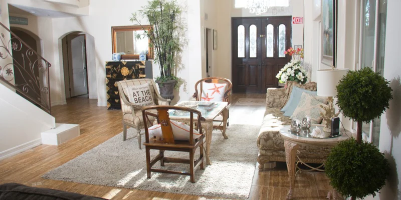 Elegant entryway with coastal decor and natural lighting.