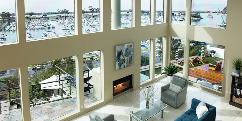 Living space with large windows and a fireplace.