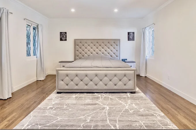 Private bedroom with bed and side-tables.