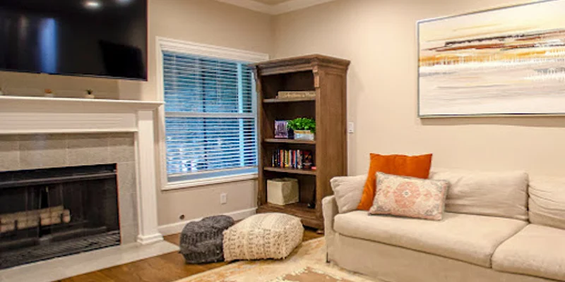Living room with a fireplace, a sofa, and a TV.