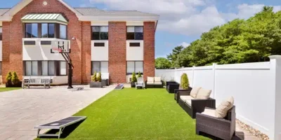Outdoor recreation area with seating and a basketball hoop.