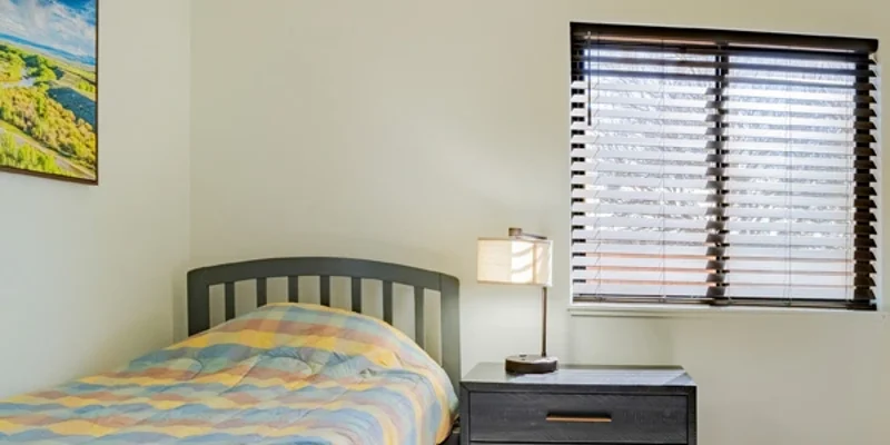 Single bed with window and nightstand