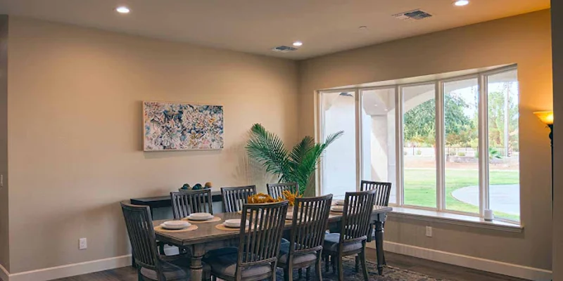 Elegant dining area with large windows and seating.