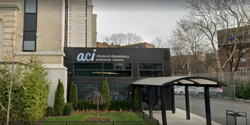 Etrance to a treatment center with green landscaping.