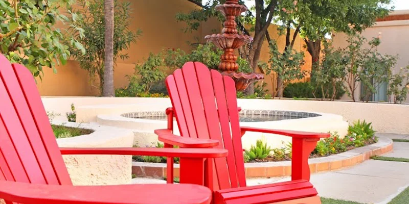 Backyard area with chairs near a fountain.