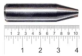 Shiny metallic cylinder with a sharpened tip. The overall length is 9&nbsp;cm and diameter about 2&nbsp;cm.