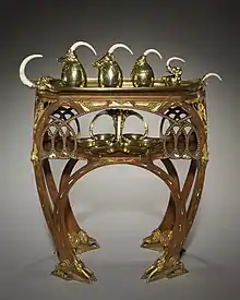 Color photograph of a tea table,  with tea and coffee service, and salver.