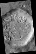 Crater floor with pits, hollows, brain terrain, and ring mold craters.  These are formed when ice leaves the ground.