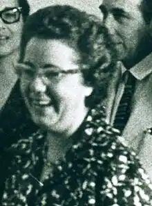 Woman in a flowered dress wearing glasses