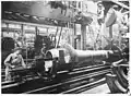 A female worker turning a barrel for a 280-mm howitzer Mle 1914 at the Harfleur plant, 1916