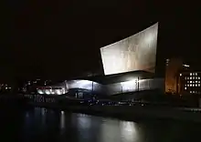 A metal-clad building with both angular and curved surfaces