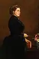 Painting of woman in profile wearing a black dress, holding a book in her left hand.