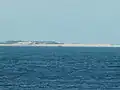 Wreck of the MV&nbsp;Sygna as seen from southern end of the beach, approximately 8.8&nbsp;km (5.5&nbsp;mi) to the south-west