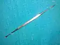 Lacrimal sac dilator with scoop