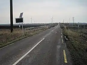 Narrow gauge bog railway crossing R502 near Derrygreenagh (geograph 4848511).jpg