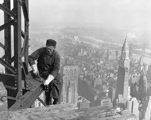 Image 3Empire State BuildingImage credit: Lewis HineA structural worker bolts beams on the framework during the construction of the Empire State Building in New York City. The 1,250-foot (380 m) building opened on May 1, 1931, at the time the tallest building in the world, overtaking the Chrysler Building (seen to the right), which had just been completed the year before. The addition of a pinnacle and antennas later increased its overall height to 1,472 feet (449 m).More selected pictures
