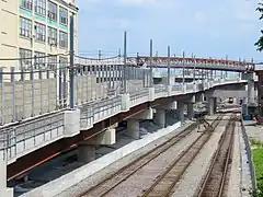 The Somerville Community Path Extension viaduct in background crossing GLX (left) and Fitchburg Line (right), Somerville