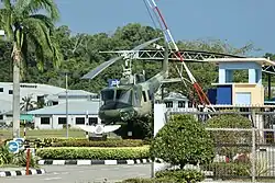 Retired RBAirF / TUDB Bell UH-1 (Bell 212, c/n: 30057, reg.: AMDB&nbsp;100) helicopter gate guardian displayed inside the main gate of the airbase, September 2023.