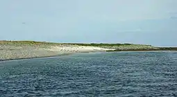 A sandy bay at the south-east corner of Holm of Scockness