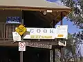 Signs on a deserted building at Cook in 2005