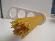 Dried spaghetti measured with a "spaghetti measure". One portion of dried pasta weighs 116&nbsp;g (4+1⁄8&nbsp;oz), twice the amount of one serving on the package (12&nbsp;mm circle or 60&nbsp;g.). The measure can portion out 1, 2, 3, or 4 servings based on the diameter of the circle.