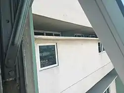 20&nbsp;in (510&nbsp;mm) separation between corridors showing apartment windows.