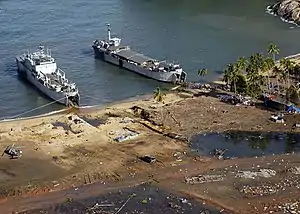 Indonesian Navy landing craft KRI Teluk Banten (516) and KRI Teluk Langsa (501) and a US Navy Seahawk helicopter in Calang