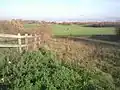 View across the park with the chimney of HM Prison Feltham visible to the right.
