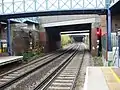 The West London Line passing under Lillie Bridge towards Kensington (Olympia) station